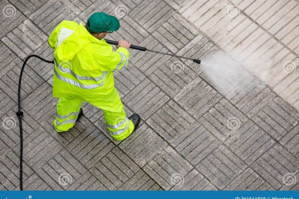 worker-cleaning-pavement-sidewalk-high-pressure-water-jet-worker-cleaning-pavement-sidewalk-high-pressure-water-jet-261611838